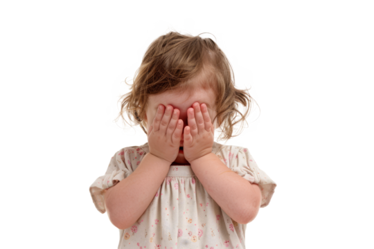 Tearful toddler on a white background, hands covering her face, expressing sadness and despair.