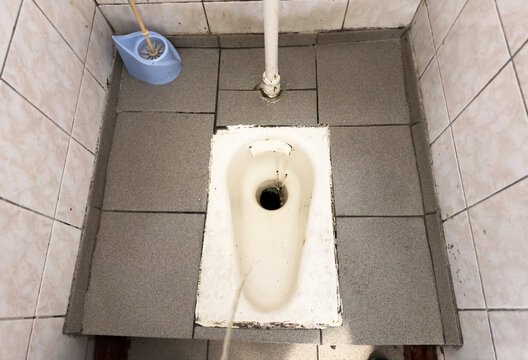 Man urinating. Tream of urine drops from height in toilet bowl. Man peeing to toilet bowl in Public toiletroom. Man pee on toilet. Standing peeing in a bowl. Urinating, peeing, pee and pissing in wc