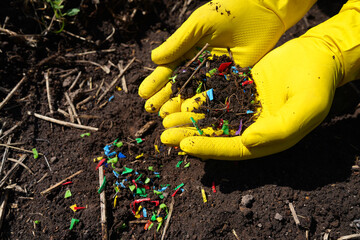 Microplastic pollution. Microplastics in ground. Soil contaminated with microplastics. Plastic...