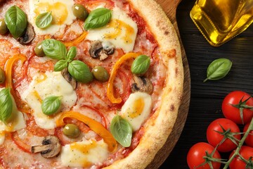 Delicious vegetarian pizza on black wooden table, closeup