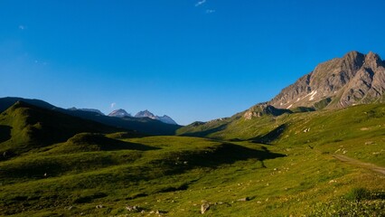 Lush green mountains under a blue sky on a sunny day in Riale, Verbano-Cusio-Ossola, Italy