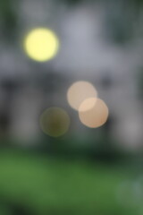 A blurry dreamy view of a street lantern glowing in the darkness.