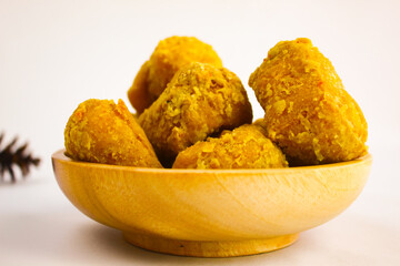 Tahu goreng cripsy, or crispy fried tofu, is one type of snack in Indonesia on wood plate isolated on white background. Perfect for recipe, article, catalogue, commercial, or any cooking contents
