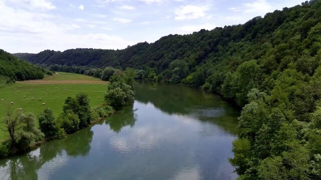 Aerial view of Kolpa River (Gorenjci pri Adle&scaron;ičih) in Slovenia (B) Specs: 4K-30fps | 45Mbps Keywords: #4K, #QHD, #drone, #background, #river, #trees, #forest, #grassfield - DATE: June 23th, 2024