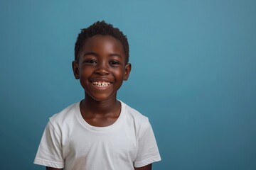 happy black boy wearing white t-shirt, in the style of mockup, on blue background
