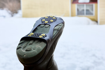 Studded overlay on sole of footwear will help prevent slipping on black ice and prevent injury.