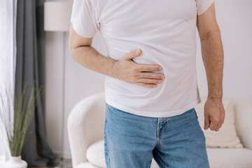Elderly man suffering from digestive problems, liver and gall bladder problems and intestinal pain...