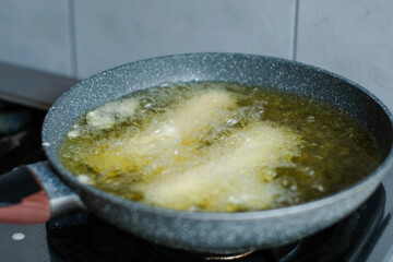 Fried banana in a pan with hot oil. Banana deep fried is a popular street food in Indonesia