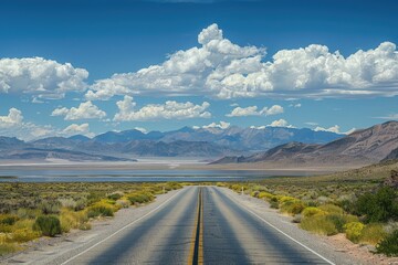 Naklejka premium Empty road leads to mountains and lake. Perfect for travel or adventure concepts.