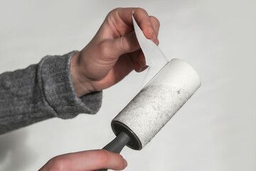 Hair remover roller. Woman using reusable clothes lint roller cleaner.	