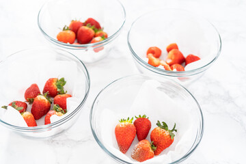 Fresh and Moldy Strawberries in a Glass Bowl on a White Napkin