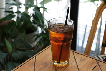 A glass of iced tea on the table

