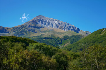 Mountain Landscape with Lush Greenery and a Blue Sky - Photo