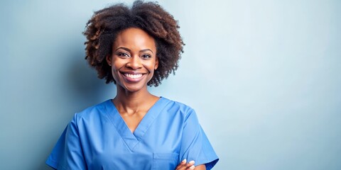 Nurse or healthcare professional looking happy and smiling. Colored woman wearing scrubs nurse uniform.  Isolated on blue or ceil background with copy space.