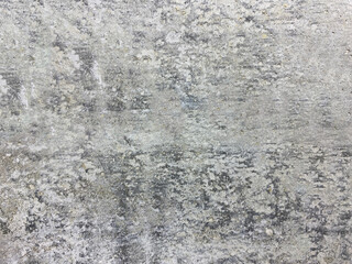 Close-up of a wall with uneven plaster and noticeable repair marks, awaiting further finishing