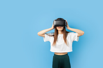 Teenage student in VR helmet, young gamer experiencing futuristic technology, person immersed in virtual reality,happy teen exploring modern gadgets, girl enjoying futuristic gaming.