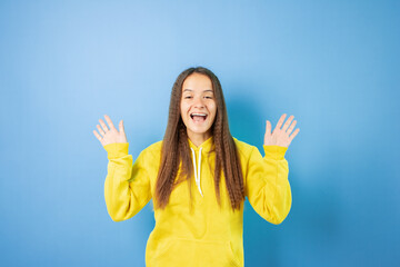Teenage student gesticulates with hands,cool teen with rock gesture, cheerful youth with a fun...