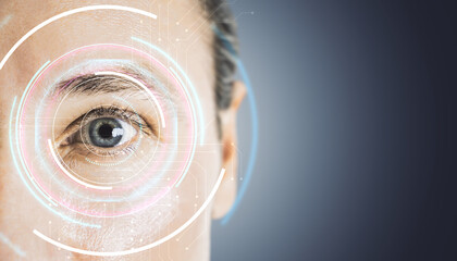 Close-up of a human eye with futuristic digital interface graphics on a gradient background.