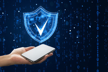 Smartphone in hand with digital shield icon and binary code background representing cybersecurity and data protection.