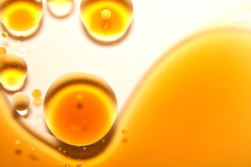 Yellow circular oil droplets floating on the water.