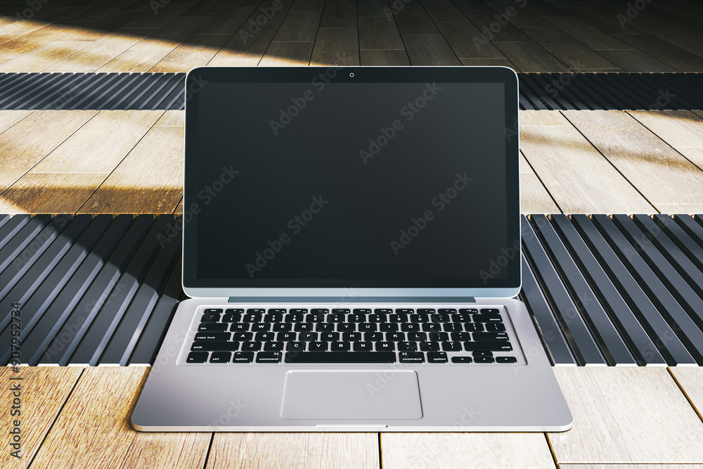 Poster modern laptop with blank screen on wooden surface. 3d rendering