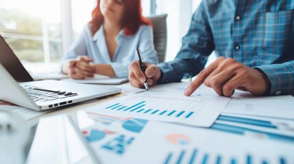 Businesspeople analyzing charts and graphs.