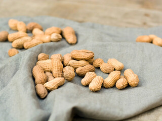 Close-up view from above of shelled peanuts in wooden table