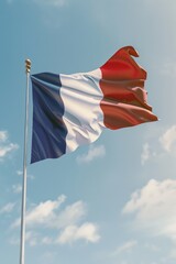 A flag with the colors blue, white, and red is flying in the sky. The flag is from France and is waving in the wind