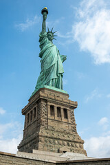 Obraz premium New York, NY, USA - August 4, 2023: Miss Liberty statue closeup, against blue sky.