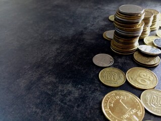 A stack of Ukrainian kopeck coins on a dark background on the right side of the photo. Background with coins and pennies.