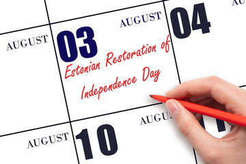 August 3. Hand writing text Estonian Restoration of Independence Day on calendar date. Save the date.