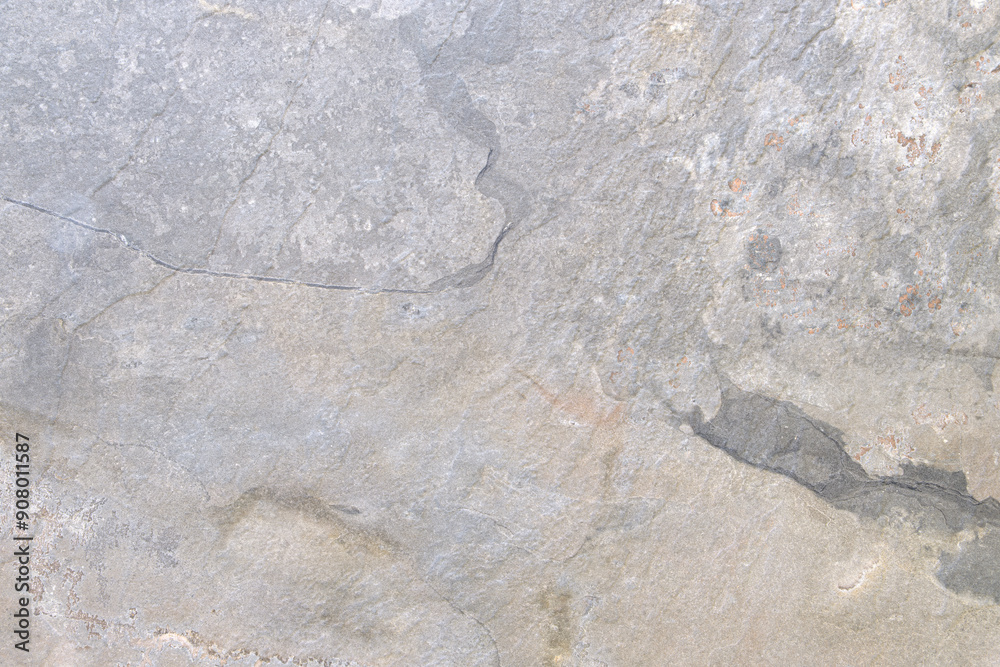 Poster a gray stone wall with a few cracks. the wall is rough and uneven, with some areas looking like they
