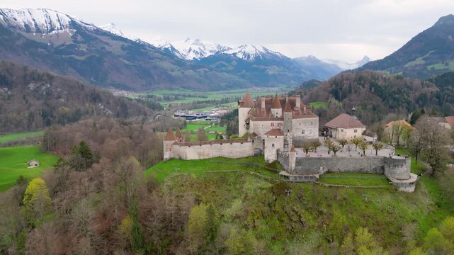 Famous Gruyere Castle in Switzerland also called Schloss Greyerz - aerial view by drone