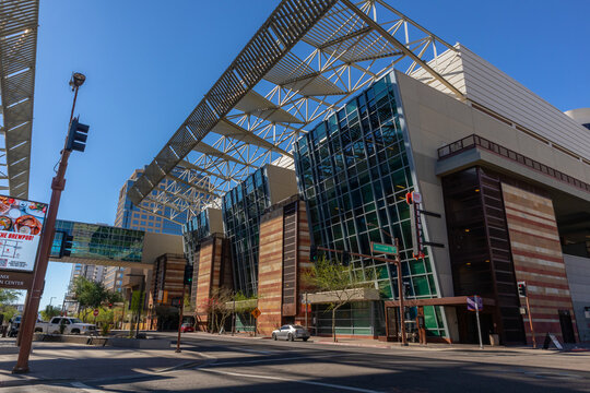 Street view of modern conference center in downtown area with sky pedestrian bridge. Phoenix, AZ, USA, 11-21-23. 