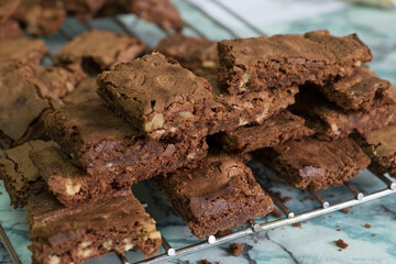 Homemade chocolate brownies with nuts cooling on wire rack