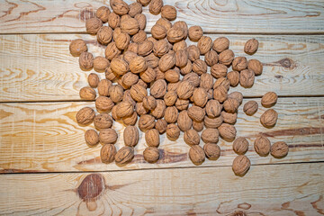 Walnuts on a wooden table. View from above.