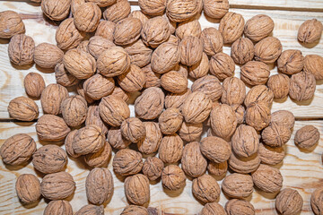 Walnuts on a wooden table. View from above.