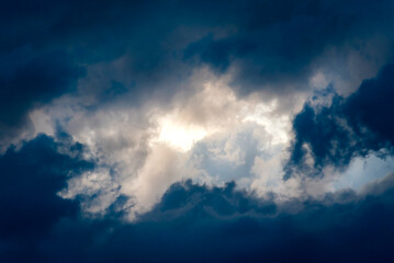 Dark and Dramatic Storm Clouds framing a clear sky Area Background