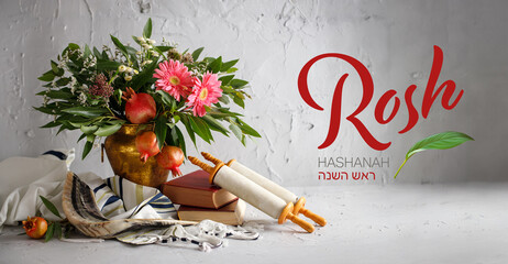 Bouquet of flowers and fruits of pomegranate, shofar (horn) and Torah on a wooden table, the concept of the Jewish new year - Rosh Hashanah.