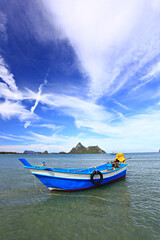 Naklejka premium Fishing boat moored in Ao Manao Behind it is a Khao Lom Muak Prachuap Khiri Khan Province 