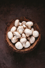 fresh mushrooms, in a wooden bowl, whole, top view, no people,