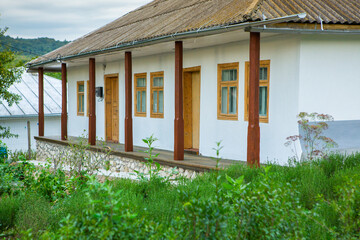 Old traditional wooden house with painted door, narrow wooden windows in the country.