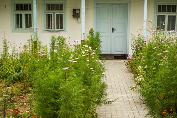 Old traditional wooden house with painted door, narrow wooden windows in the country.