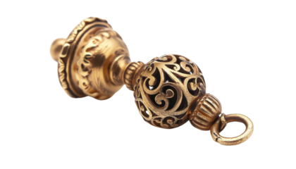 A close-up of an ornate gold pendant with intricate filigree details. The pendant is isolated on a black background.