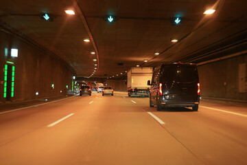 A car tunnel on a high-speed road with cars.