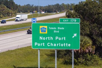 Highway interchange exit sign with direction to North Port and Port Charlotte in Florida....