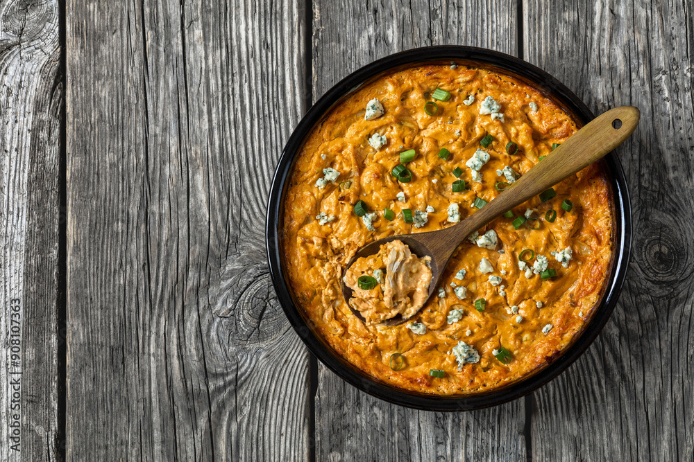 Wall mural hot buffalo chicken dip in baking dish, top view