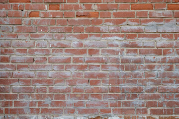 Background, old red brick wall, fragment of ancient fortress