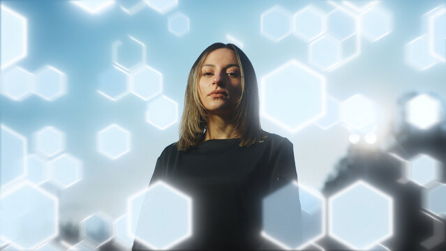 Young female soccer player standing confidently against a backdrop of glowing hexagonal patterns and light trails. Ideal for illustrating themes of sports, technology, and futuristic design.	
 - Powered by Adobe