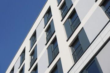 Modern apartment building against a clear blue sky. Residential building architecture. Urban real...